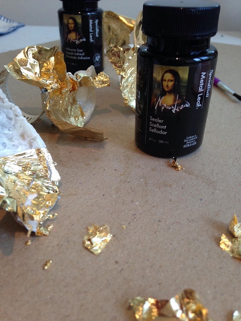 Applying goldleaf to shells